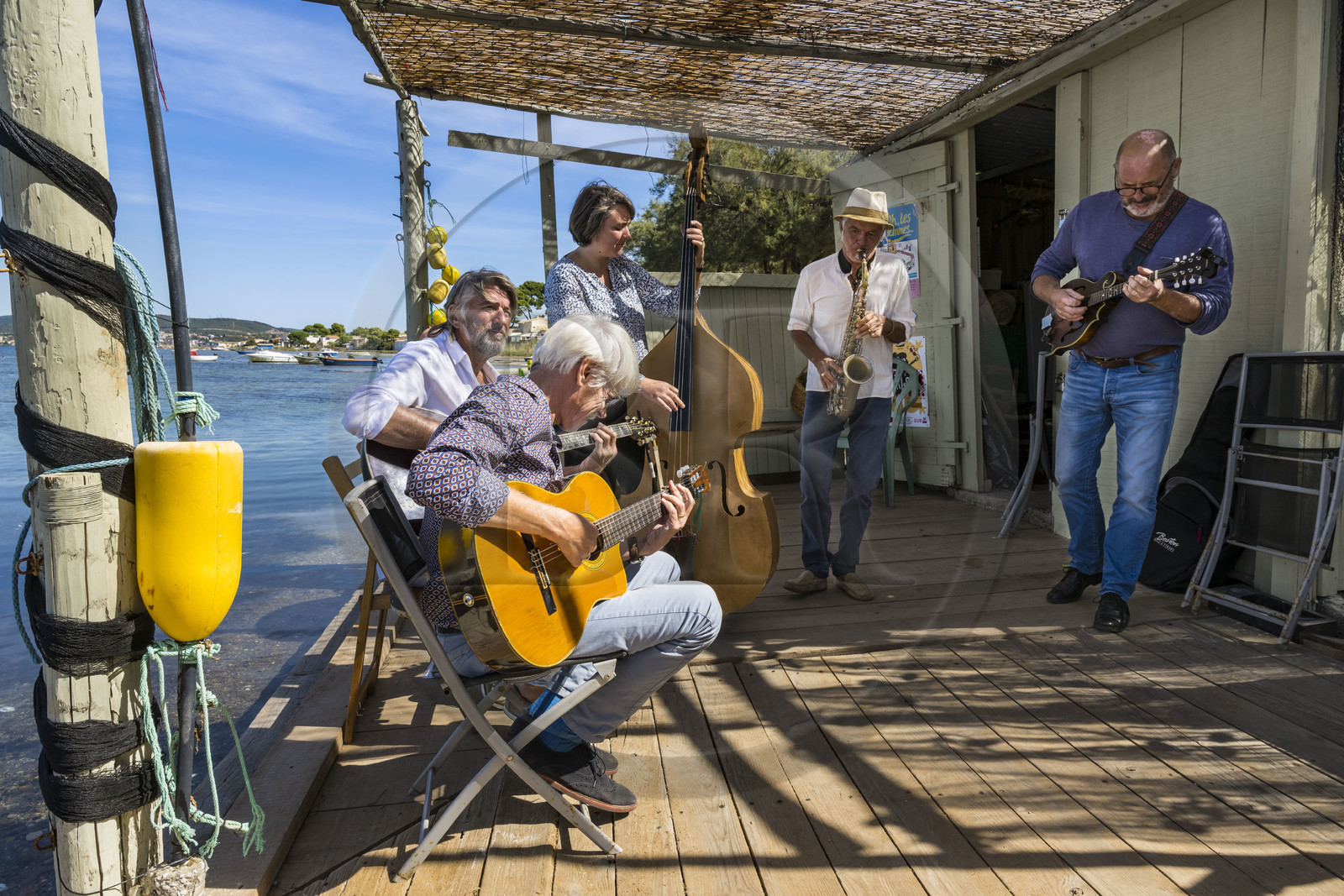 France, Herault, Sete, Pointe du Barrou on the banks of the Etang de Thau, the music group Au Bois de mon cœur which reinterprets the songs of Georges Brassens, it is led by the Sète fisherman Jean-Louis Lambert on vocals and guitar, Georges Cabaret on solo guitar, Guy Blanc dit Guet on alto sax, Denis Benito on bluegrass mandolin and Tatiana on double bass