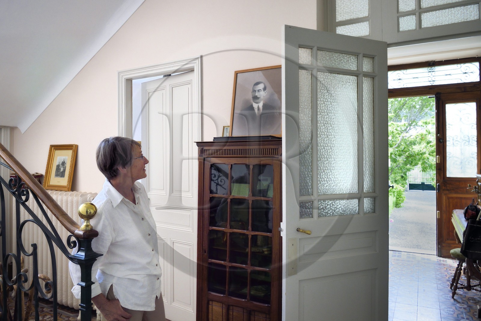 France, Alpes de Haute Provence, Ubaye valley, Jausiers, mexican villa known as Villa San Carlos, Sophie Meche-Fortoul granddaughter of Eugene Fortoul (framed portrait) who emigrated to Mexico in the early 20th century