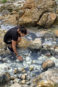 Caribbean, Dominica Island, Castle Bruce, Morne Trois Pitons National Park listed as World heritage by UNESCO, Valley of Desolation, river of hot springs, whose unique color is due to the presence of calcium, carbon, sulfur and iron, hiker on the trail leading to Boiling Lake