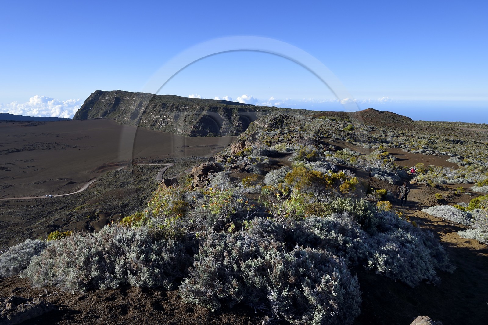France, Reunion island (French overseas department), Reunion National Park listed as World heritage by UNESCO, on the slopes of the Piton de la Fournaise volcano, hikers on the Ste Therese oratory trail above the Plaine des Sables that we can see below