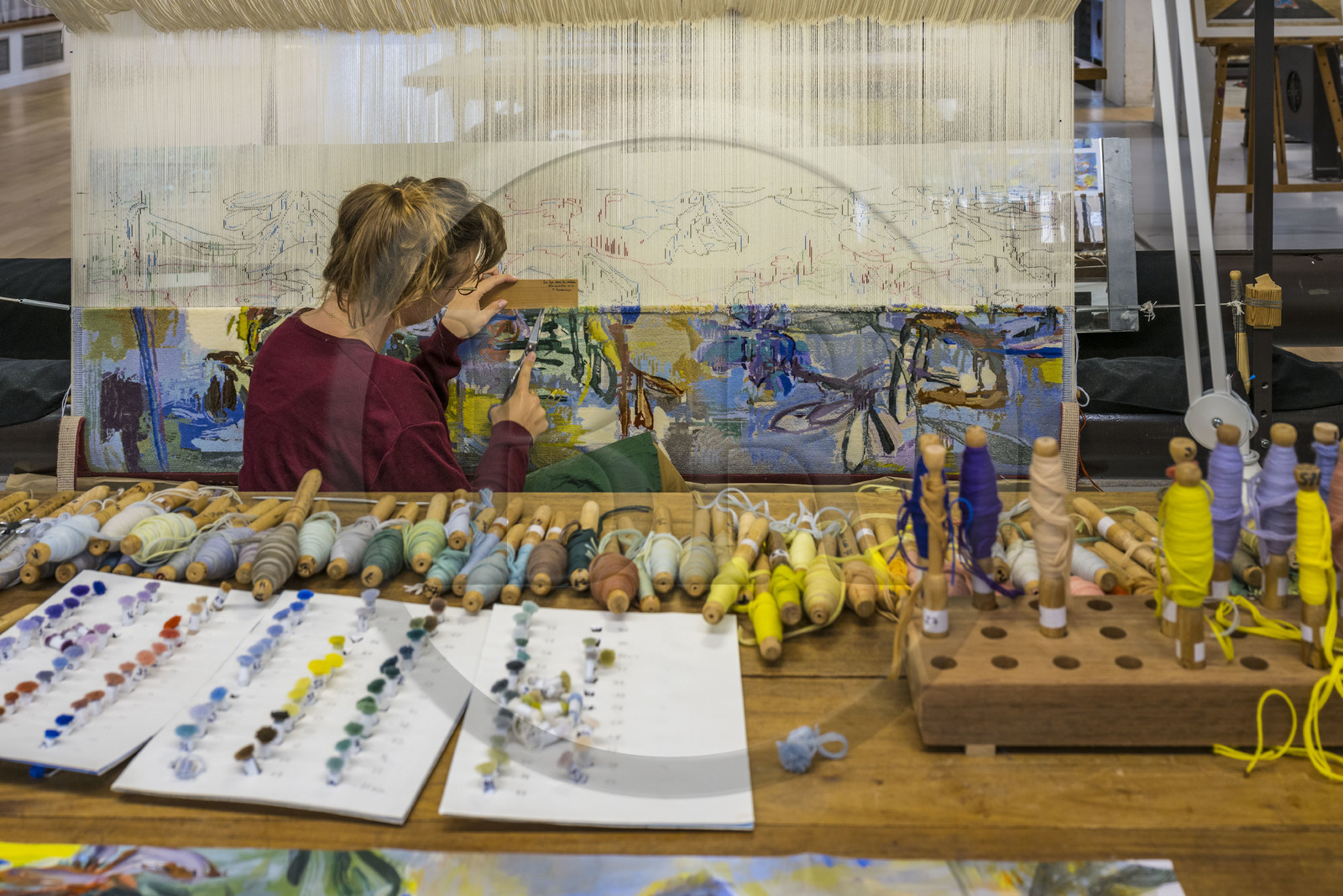 France, Herault, Lodève, Manufacture de la Savonnerie (Savonnerie manufactory) unique annex of the National Carpet Factory of the Savonnerie des Gobelins in Paris, realization by the weaver Kristell Corbinais on a loom of a seat tapestry for the bench L'Iris dans la vallée designed by Philippe Borderieux, mowing action