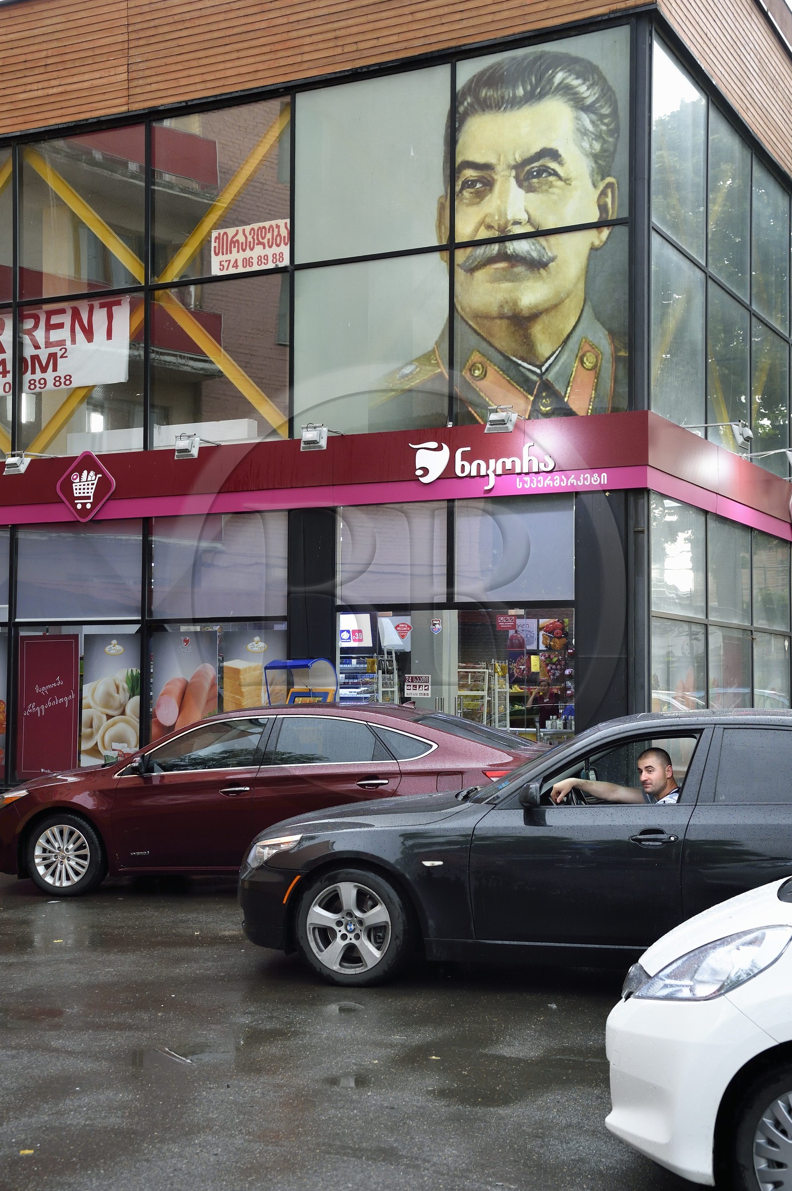 Georgia, Shida Kartli, Gori, hometown of Joseph Stalin, portrait of the dictator over a supermarket
