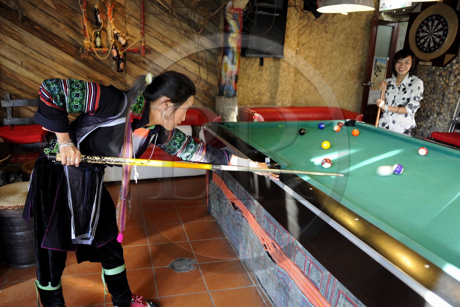 Vietnam, Lao Cai province, city of Sapa, young women from Black Hmong minority group playing pool