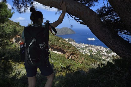 Italy, Sicily, Aeolian Islands, listed as World Heritage by UNESCO, Lipari Island, Lipari, hiker observing Lipari dominated by his citadel