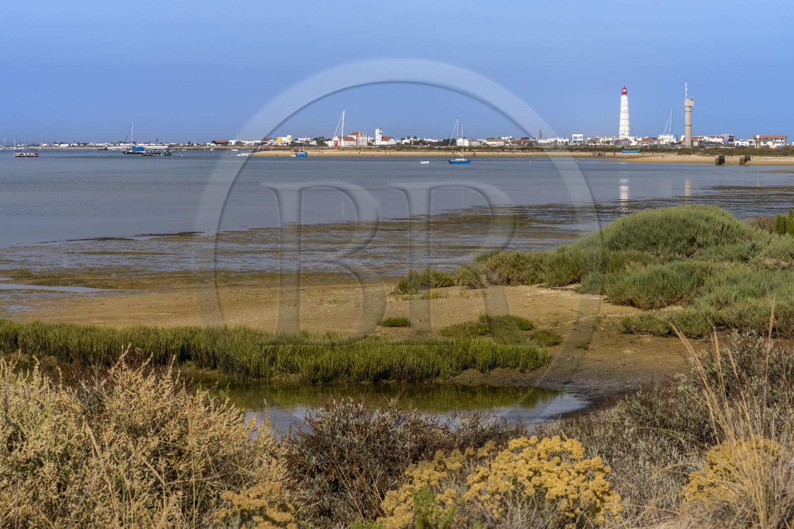 Portugal, Algarve, Ria Formosa Natural Park, Faro, Island of Barreta or Deserta (Ilha da Barretta or Deserta), the lighthouse of Ilha do Farol part of  Ilha da Culatra in the background