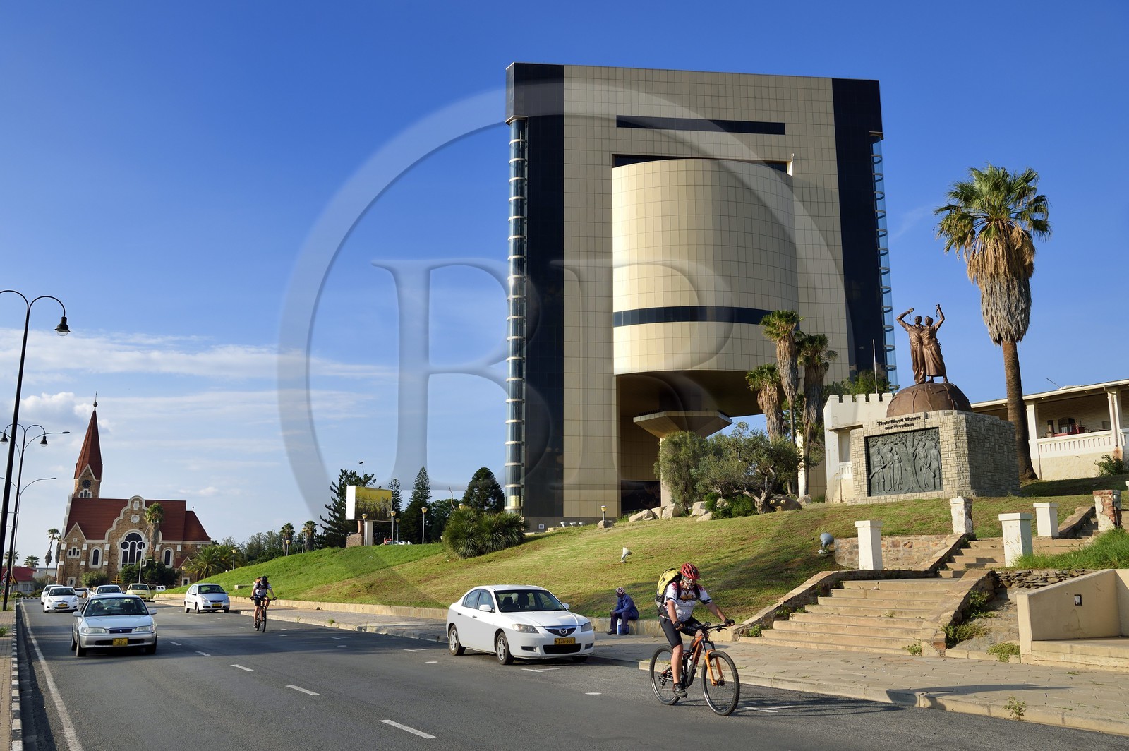 Namibia, Khomas region, Windhoek, Christ Church (or Christuskirche), Lutheran church designed by architect Gottlieb Redecker and the Independence Memorial Museum built by North Korea, the Alte Feste (Old Fortress) on the right with the Liberation statue Their Blood Waters Our Freedom