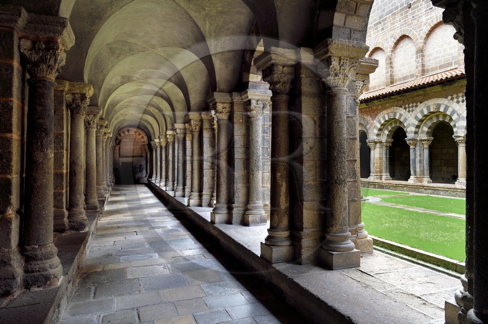 France, Haute Loire, Le Puy en Velay, Routes of Santiago de Compostela, the 12th century Our Lady (Notre-Dame-de-l'Annunciation) cathedral listed as World heritage by UNESCO, the cloister decorated with polychrome arcades