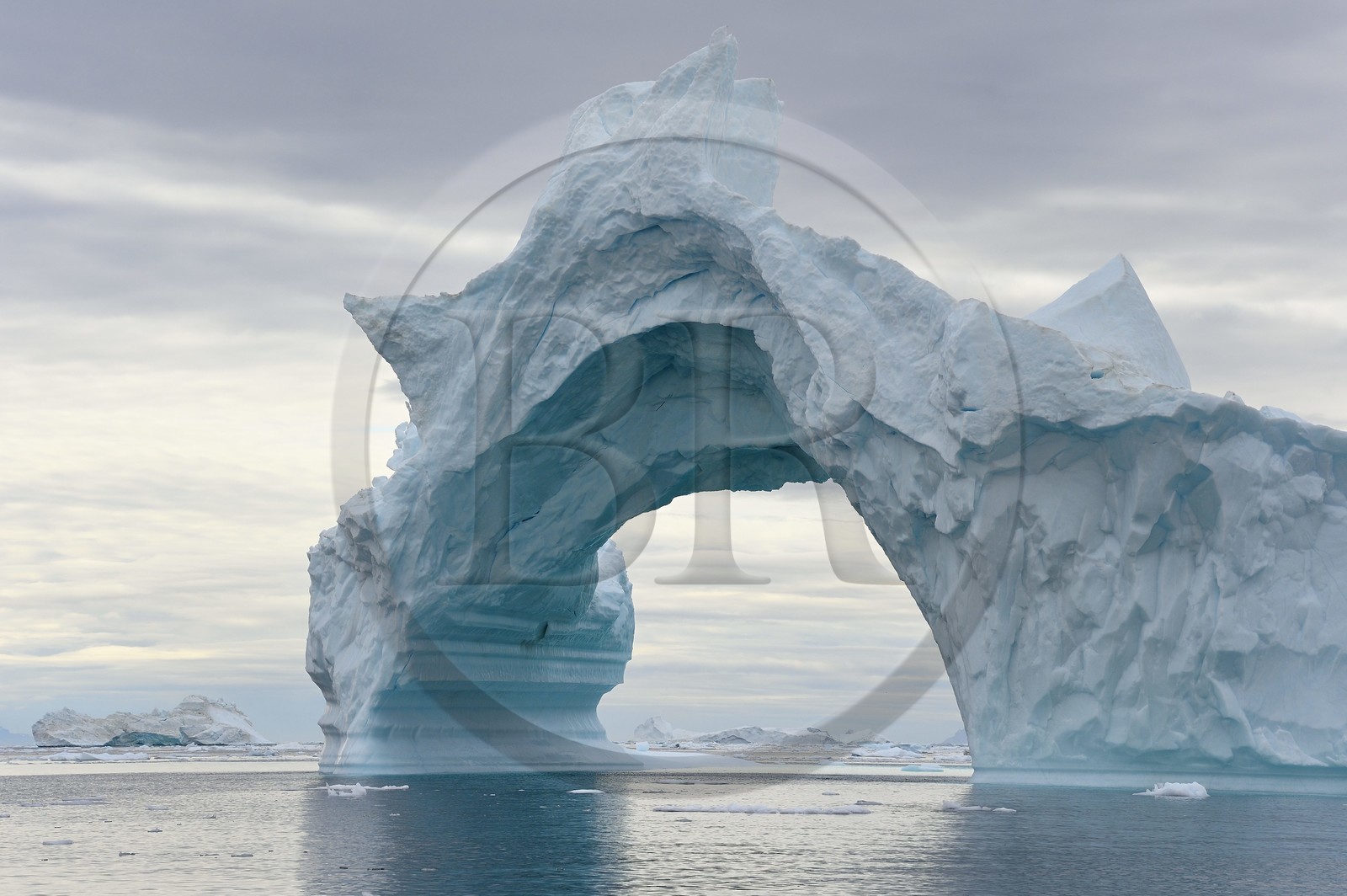 Greenland, North West coast, Baffin Sea, Inglefield Fjord towards Qaanaaq, iceberg forming an arch