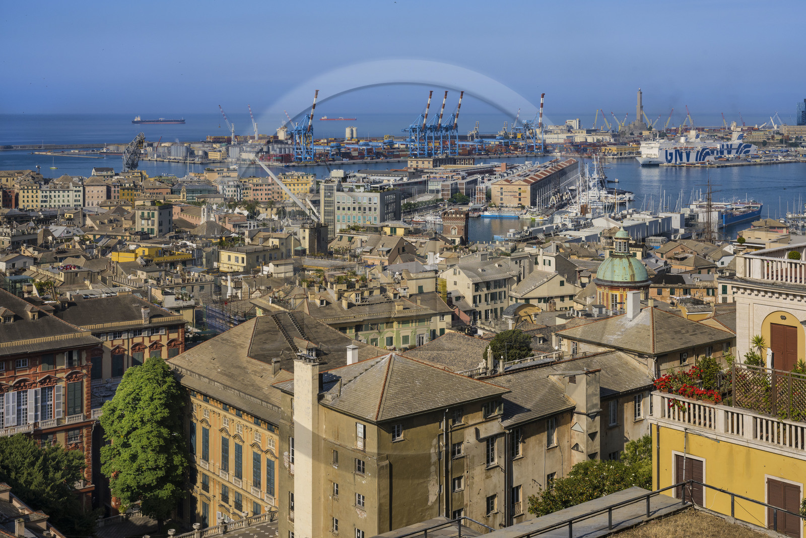 Italy, Liguria, Genoa, Rolli Palace listed as World Heritage by UNESCO in the Strada Nuova today via Garibaldi in the foreground, the Porto Antico (Old Port) and the commercial port overlooked by the lighthouse of La Lanterna in the background, seen from the Belvedere of Castelletto
