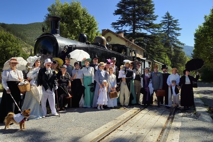 France, Alpes-Maritimes, Puget Theniers, the Train des Pignes historic train, members of the AHVAE (Association d'histoire vivante et de d'archeologie expérimentale) in Belle Epoque costume in front of the steam engine