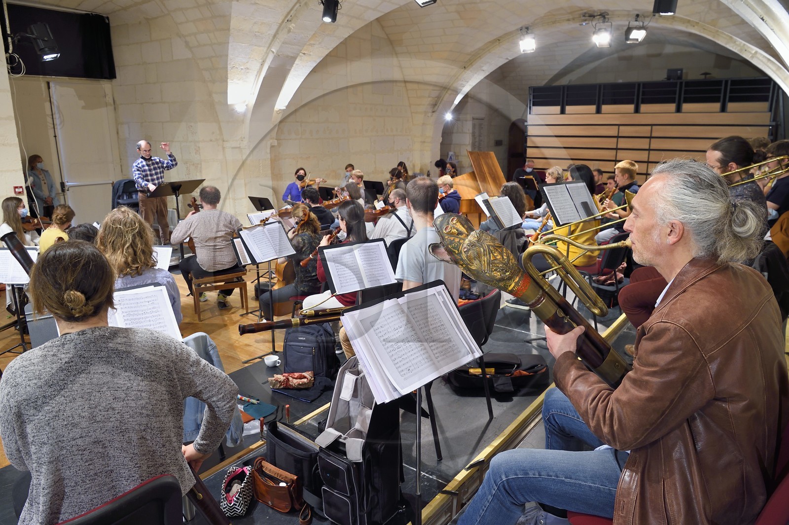 France, Charente-Maritime, Saintonge, Saintes, Abbaye aux Dames - la cité musicale, concert rehearsals of the Jeune Orchester de l'Abbaye conducted by Christopher Coin, an orchestra in training in conjunction with the University of Poitier, a musician plays the Serpent (a wind musical instrument) in the foreground
