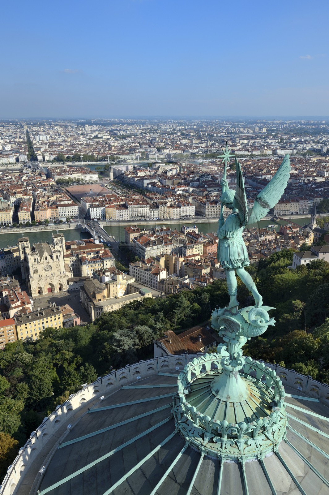 France, Rhone, Lyon, historical site listed as World Heritage by UNESCO, Vieux Lyon (Old Town), the statue of the Archangel Saint Michael slaying the dragon sculpted by Millefaut on the apse of the the Notre Dame de Fourviere Basilica in the foreground, Saint Jean Cathedral (Saint John's Cathedral) and the district of La Presqu'Ile in the background
