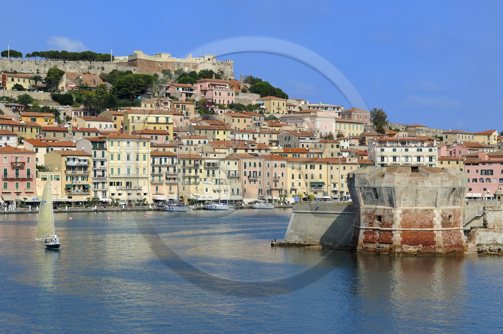 Italy, Tuscany, Elba Island, Portoferraio overlooked by the Medici fortifications and the Torre del Martello Tower at the entrance of the port