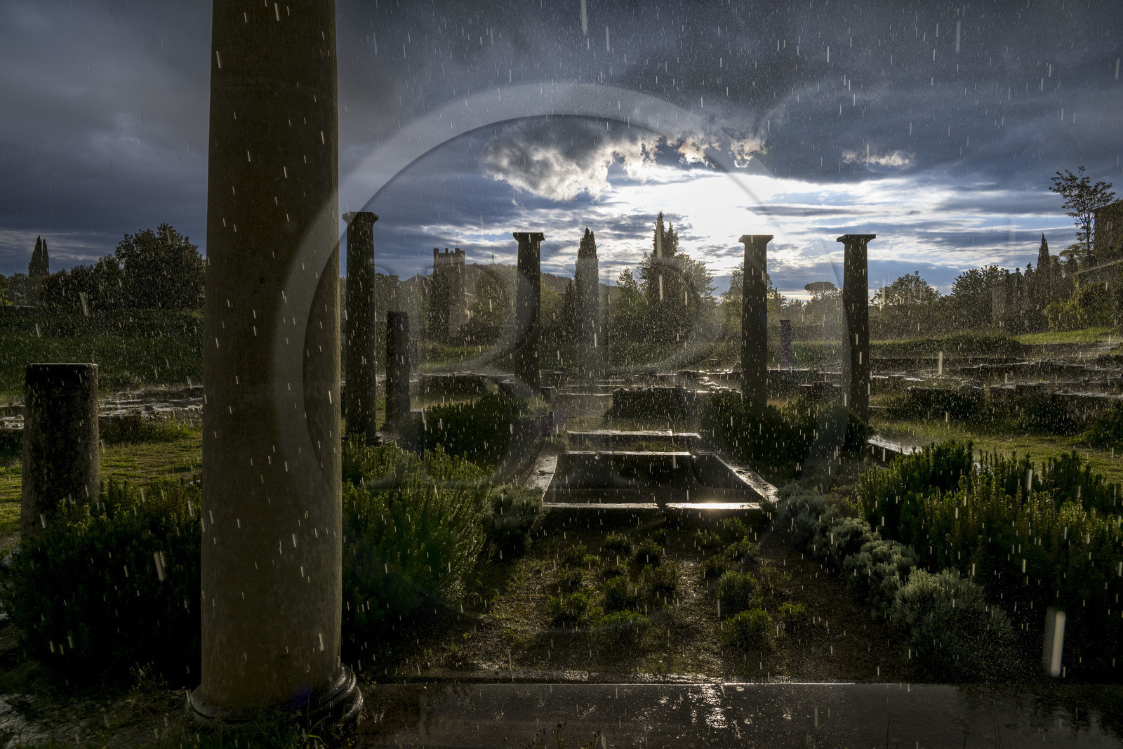 France, Vaucluse, Dentelles de Montmirail mountains,  Vaison la Romaine, Villasse archaeological site, remains of the House of the Dolphin whose impluvium can be seen under a rain shower