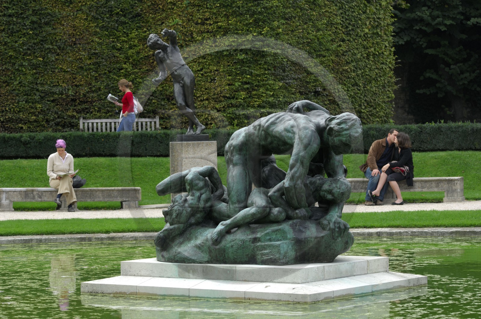 France, Paris,  the Rodin museum in the Hotel Biron,  the sculpture Ugolin and lovers kiss in the background