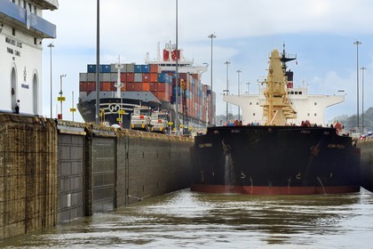 Panama, Canal de Panama, écluses de Miraflores, mules mécaniques ou locomotives électriques guidant un cargo Panamax entre les murs de l'écluse