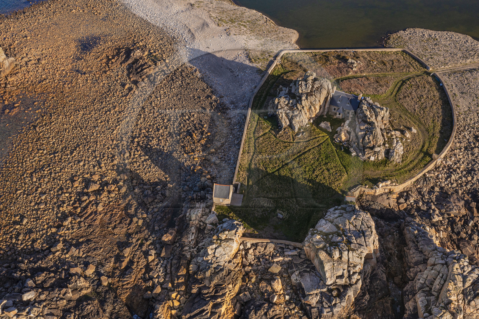 France, Cotes-d'Armor, Cote d'Ajoncs, Plougrescant, site of the Plougrescant Gouffre, the small house of Castel Meur, any representation for commercial use of this house is prohibited (aerial view)