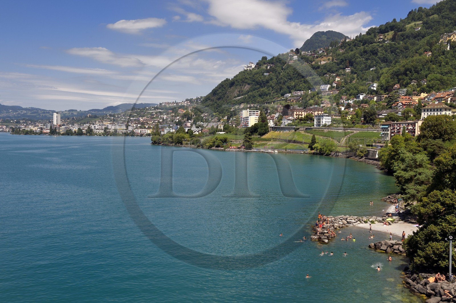Switzerland, Canton of Vaud, Veytaux, the small beach at the foot of the Chillon castle on the shores of Lake Geneva (Lac Leman) and Montreux in the background