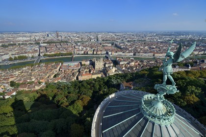 France, Rhone, Lyon, historical site listed as World Heritage by UNESCO, Vieux Lyon (Old Town), the statue of the Archangel Saint Michael slaying the dragon sculpted by Millefaut on the apse of the the Notre Dame de Fourviere Basilica in the foreground, Saint Jean Cathedral (Saint John's Cathedral) and the district of La Presqu'Ile in the background