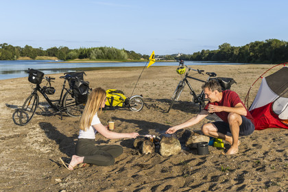 France, Maine-et-Loire, Loire valley listed as World Heritage by UNESCO, Saumur towards Saint-Hilaire, cycling along the banks of the Loire, camping for the night on one of the sandbanks forming islands on the Loire, roasting marshmallows
