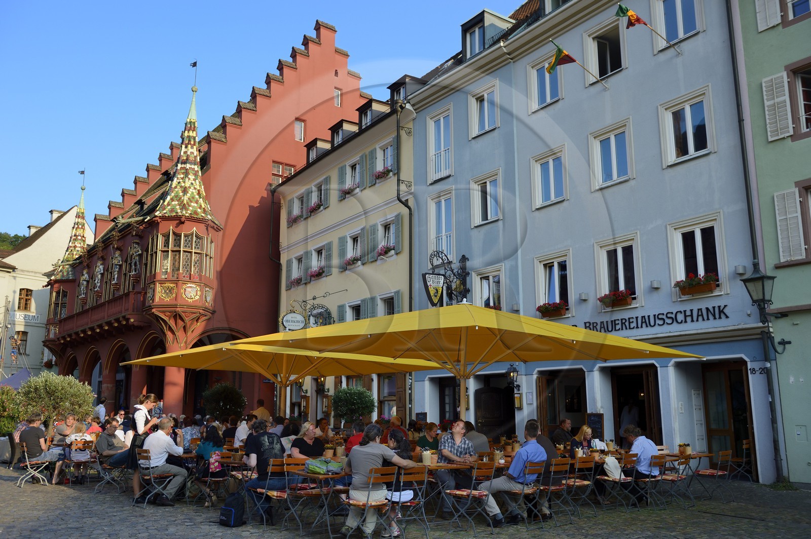 Germany, Baden-Wurttemberg, Freiburg im Breisgau, the Historical Merchants Hall of the early 16th century on the Munsterplatz and Terrace of the restaurant Oberkirch