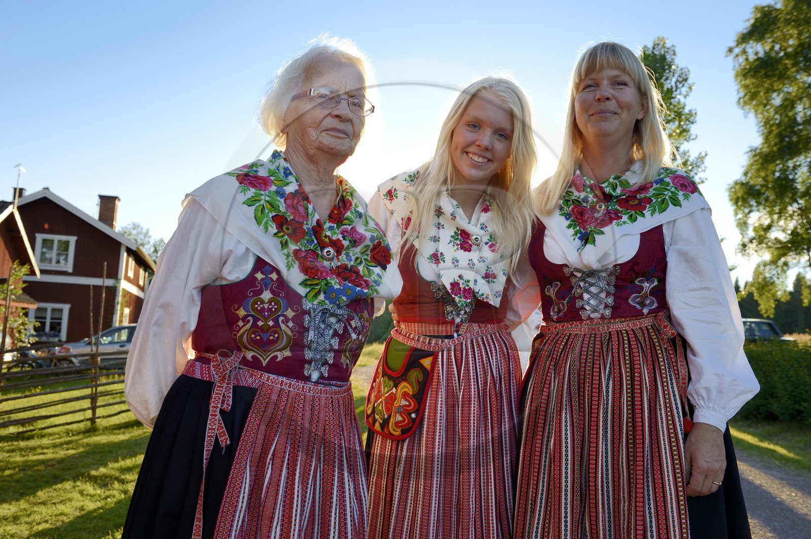 Sweden, Dalarna County, Leksand area, Midsummer celebrations in the tiny hamlet of Hjulbäck, three women in traditional costumes, grandmother, mother and daughter