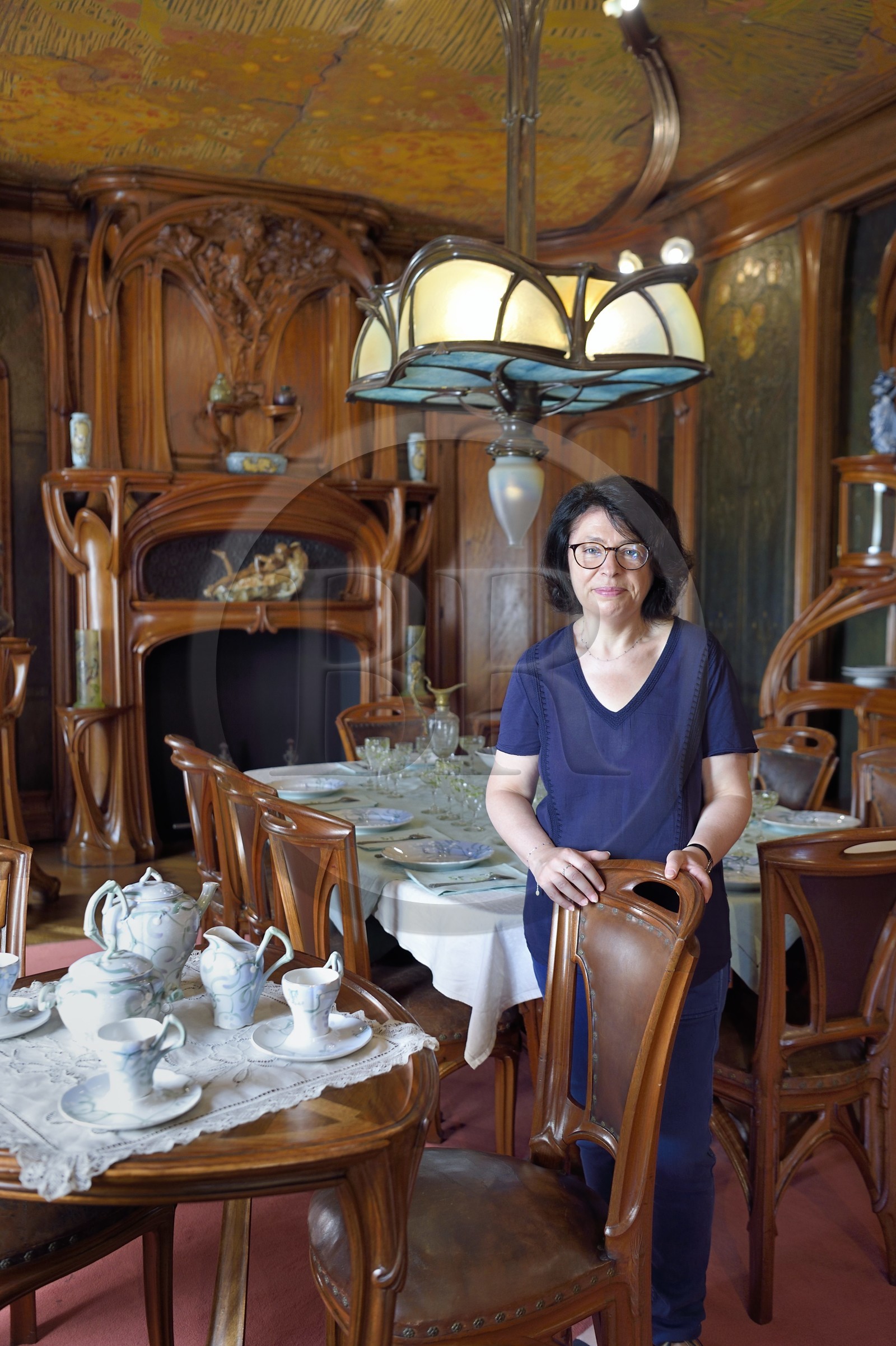 France, Meurthe-et-Moselle, Nancy, Ecole de Nancy Museum, the Art Nouveau dining room of Masson (1903-1906), furniture and woodwork by Eugène Vallin, leather panels and ceiling by Victor Prouvé, the curator Valerie Thomas