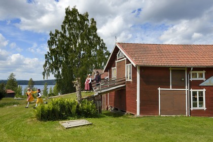 Sweden, Dalarna County, Leksand area, family in traditional costumes for the Midsummer celebrations in the tiny hamlet of Sunnanäng on the shore of Lake Siljan