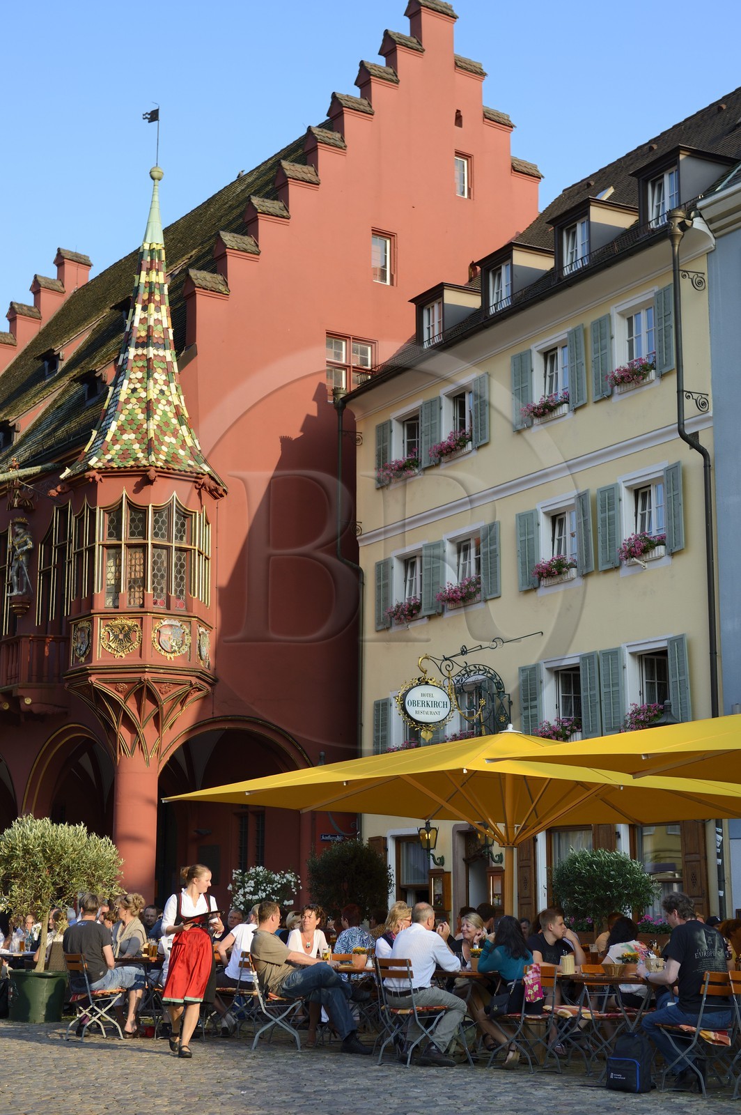Germany, Baden-Wurttemberg, Freiburg im Breisgau, the Historical Merchants Hall of the early 16th century on the Munsterplatz and Terrace of the restaurant Oberkirch