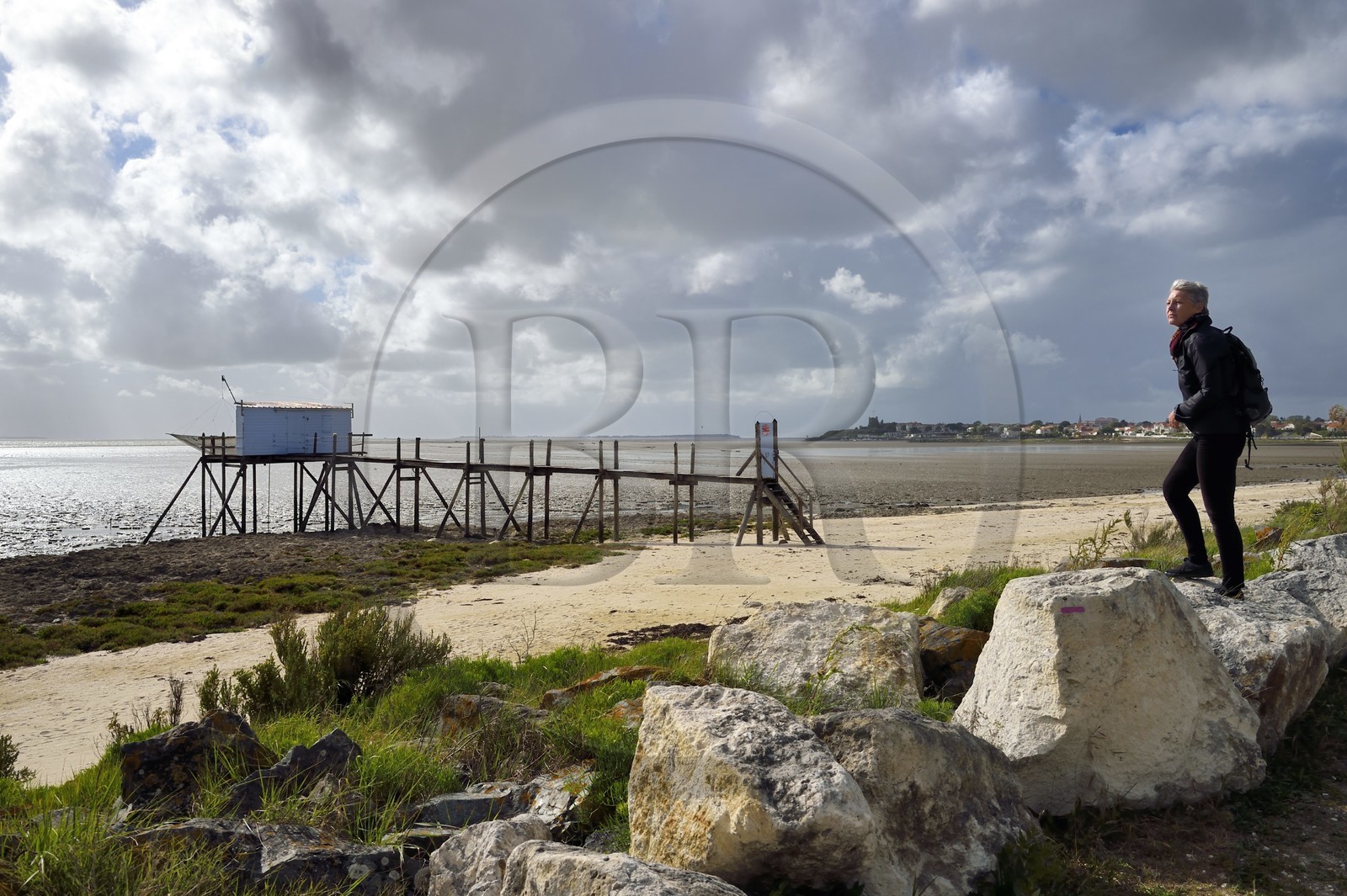 France, Charente-Maritime, Fouras, Esperance beach discovered by the tide and carrelet huts, the Fort de Fouras fortified by Vauban in 1672 in the background