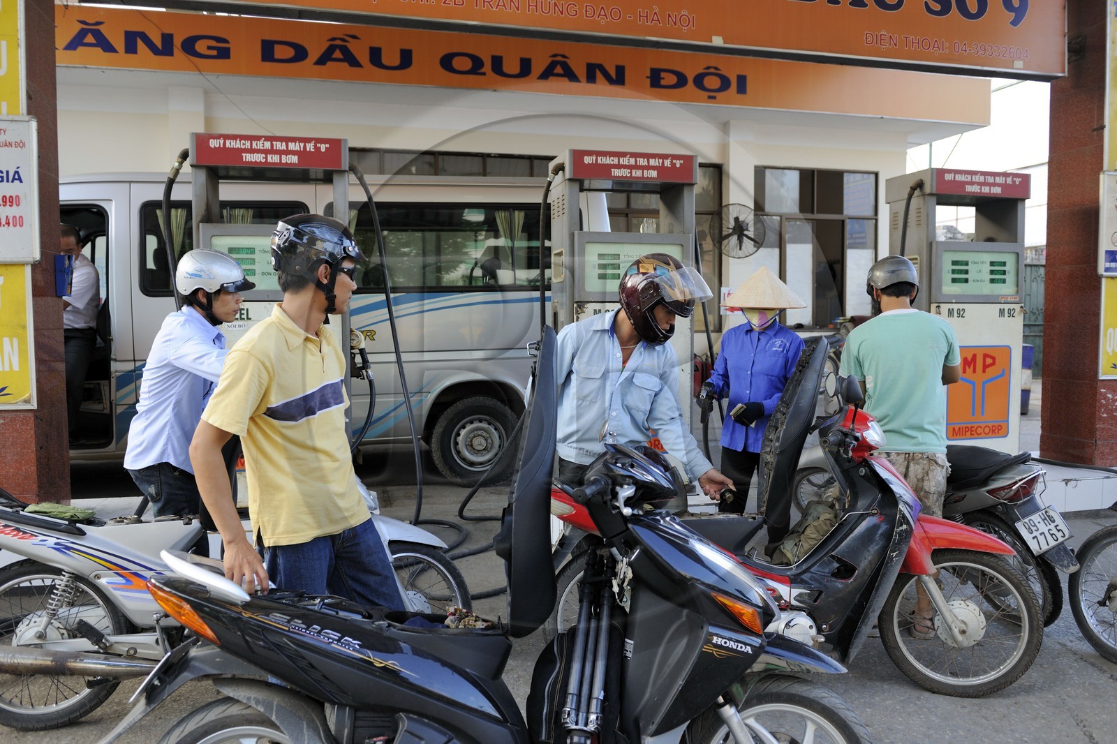 Vietnam, Hanoi, motorcycle traffic, petrol station