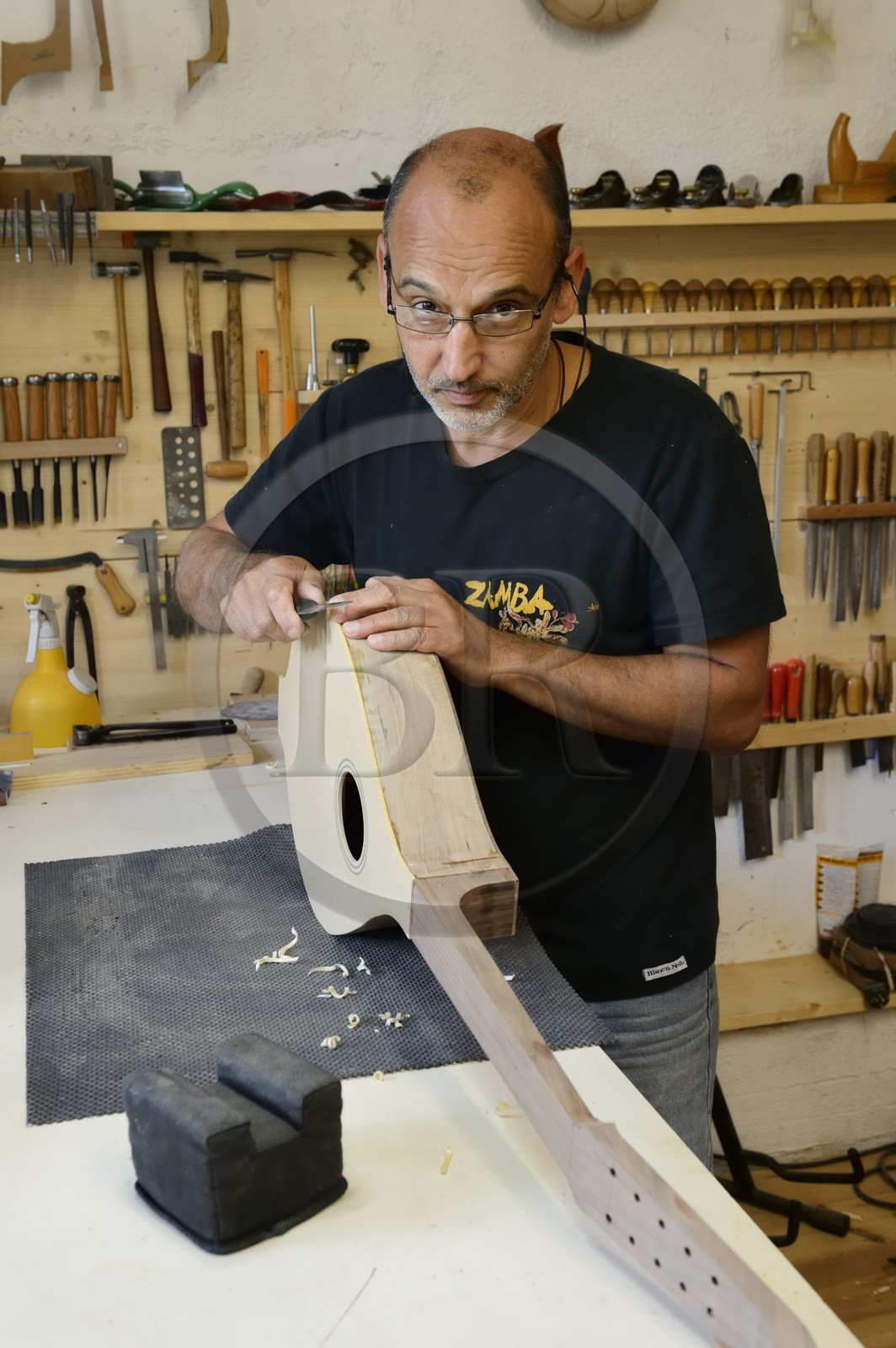 France, Haute Corse, Balagne, village of Pigna, the stringed-instrument maker Ugo Casalonga in his workshop making a cetera (cithern)