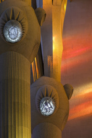 Spain, Catalonia, Barcelona, Eixample district, Sagrada Familia basilica by Catalan modernist architect Antoni Gaudi, listed as a UNESCO World Heritage Site, above the node, the columns of the central vessel (nave) are subdivided into branches like a tree, illuminated by the warm projections of the stained glass windows on the Passion facade