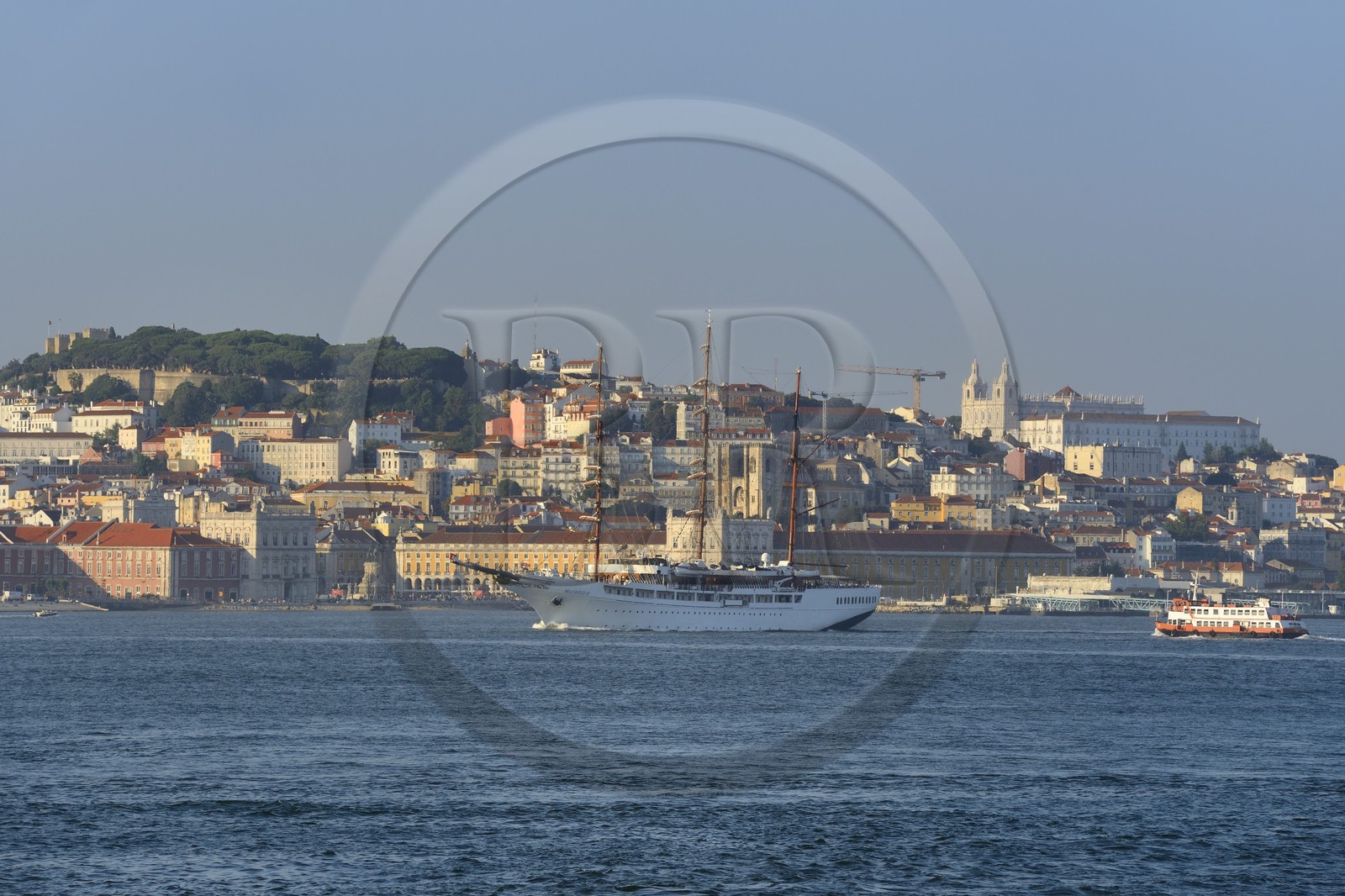 Portugal, Lisbon, the luxurious cruising yacht Sea Cloud II and a ferry on the Tagus river (rio Tejo) and the historical center in the background