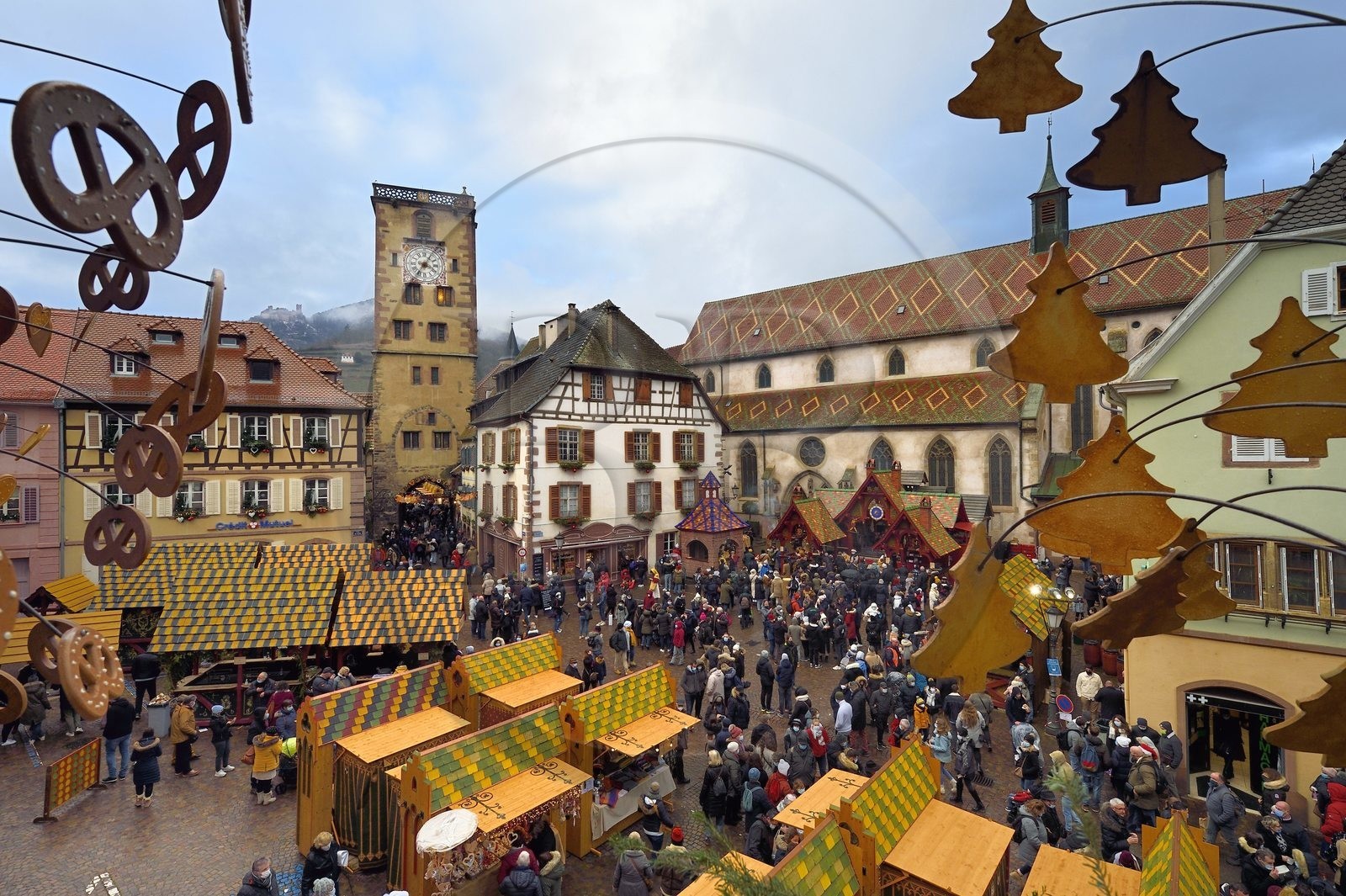 France, Haut Rhin, Strasbourg, Ribeauvillé, the medieval christmas market with in particular a stall offering wild boar on the spit on the square in front of the Augustinian convent church and the Tour des Bouchers (Butchers Tower)