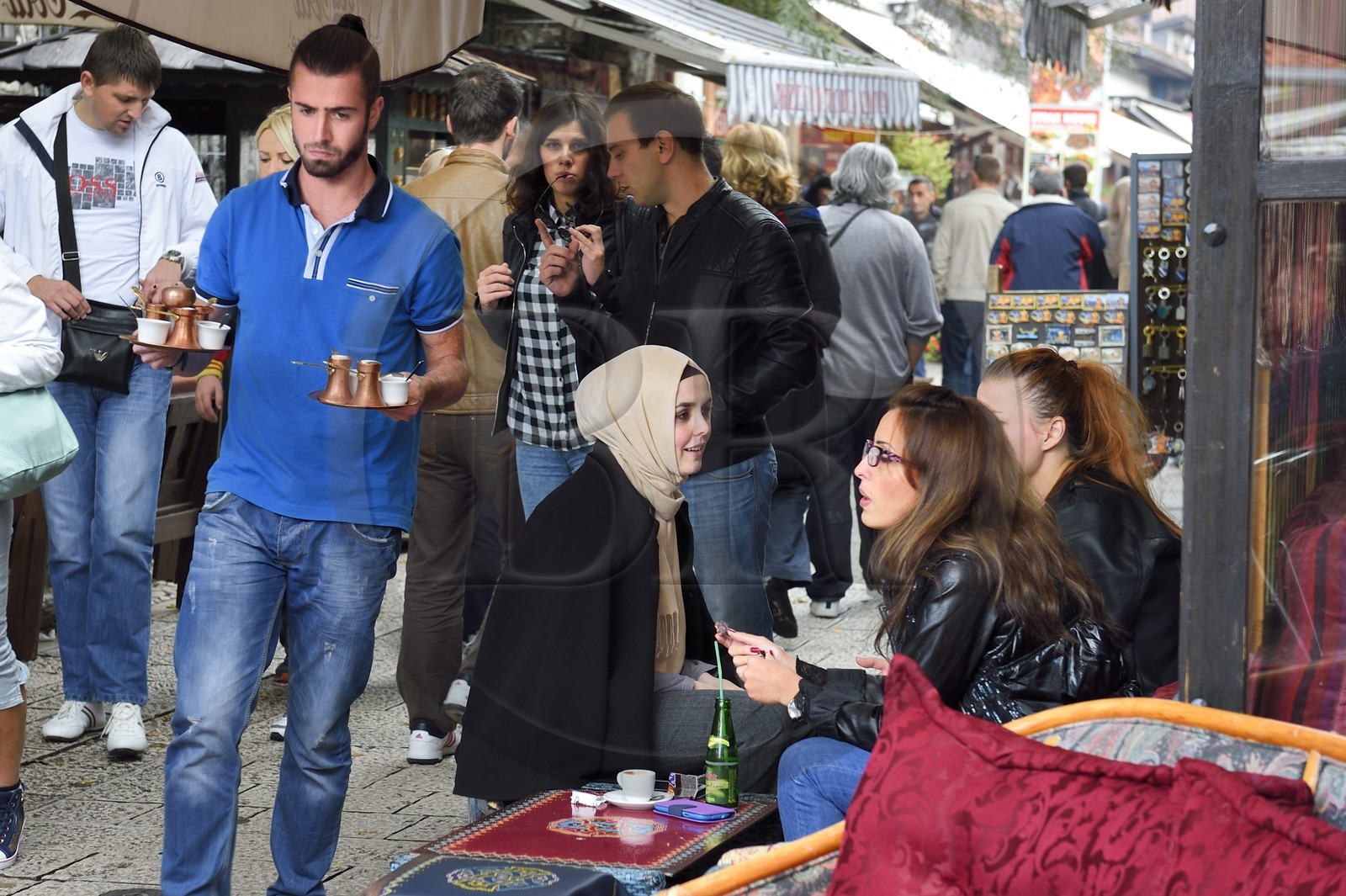 Bosnie-Herzégovine, Sarajevo, quartier de Bascarsija dans la vieille ville, la rue Bravadziluk célèbre pour ses restaurants de Burek et cevapi, jeunes filles voilées et non voilées assises ensemble à la terrasse d'un café