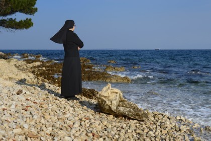 Croatia, Dalmatia, Dalmatian Coast, Ugljan Island, Franciscan St. Jerome Convent of the Congregation of the Sisters of Mercy, sister Theresija like contemplating the sea in her spare time