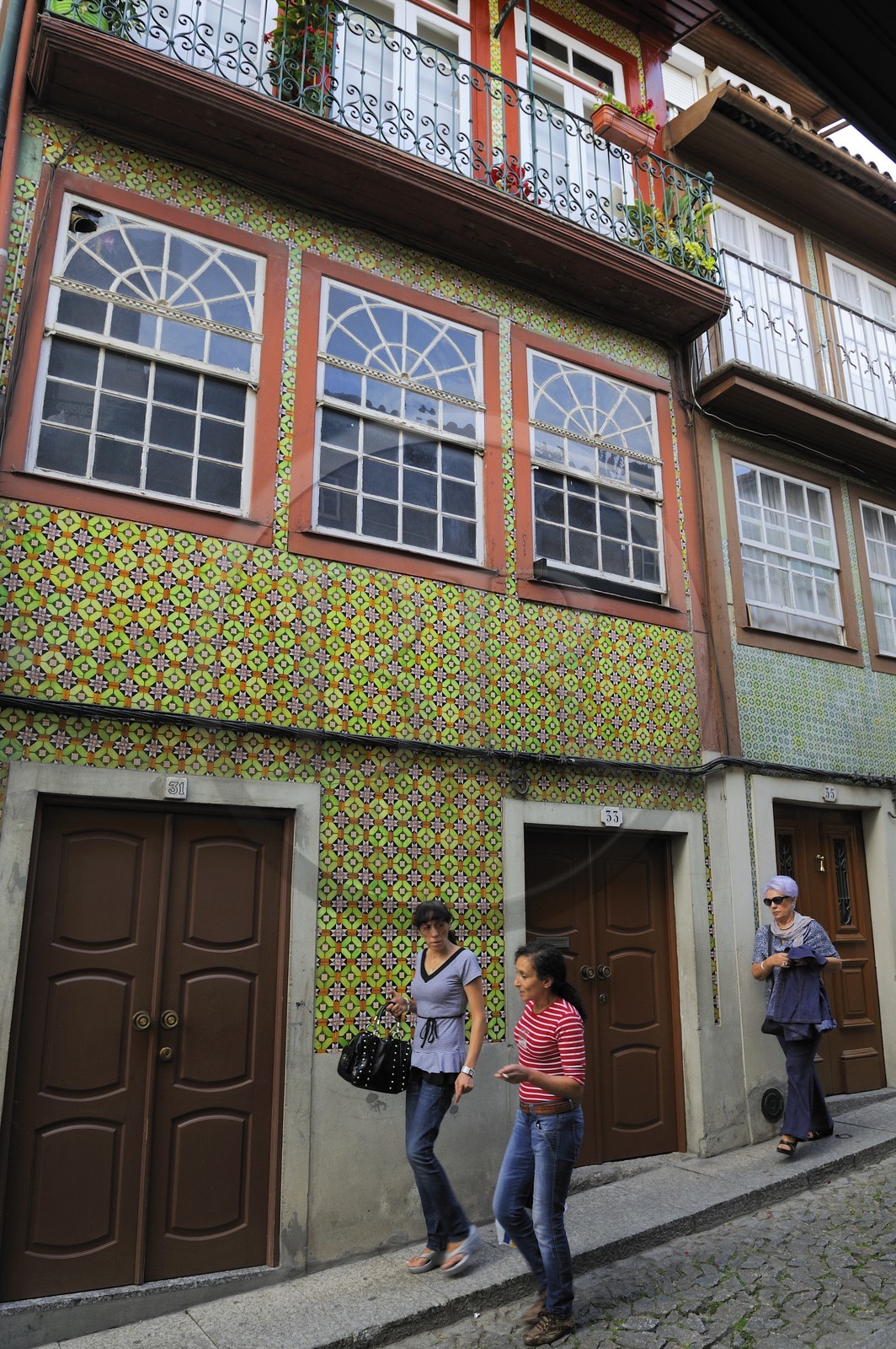 Portugal, Minho region, Guimaraes, town listed as World Heritage by UNESCO, home with tiles in the street das Trinas
