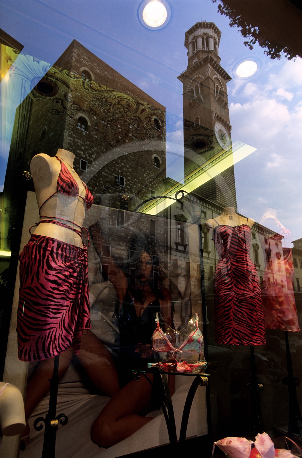 Italy, Venetia, Verona, Piazza Erbe, Lamberti Tower reflecting in a window of a shop