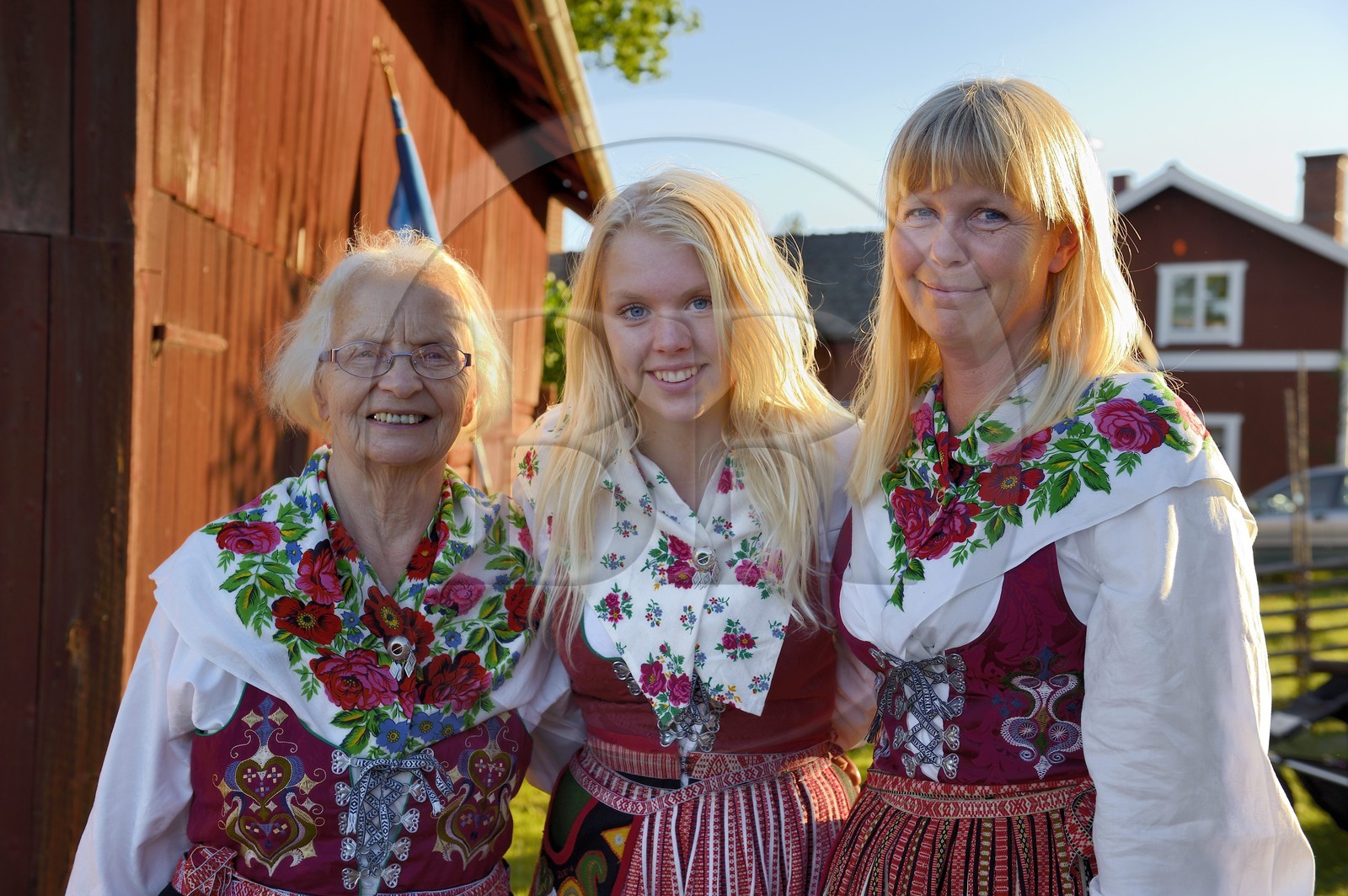 Sweden, Dalarna County, Leksand area, Midsummer celebrations in the tiny hamlet of Hjulbäck, three women in traditional costumes, grandmother, mother and daughter