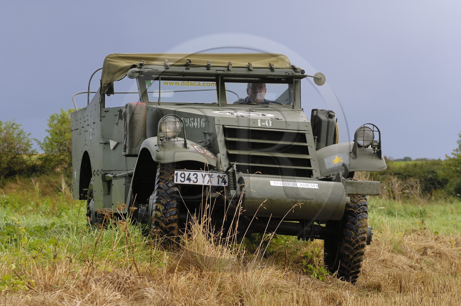 France, Calvados, Caen, Jean Pierre Benamou, president of D-Day Academy guiding visitors on the Normandy landing sites : here a white scout car M3A1