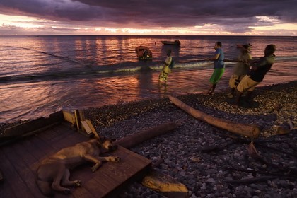 Caribbean, Dominica Island, Soufriere Bay, the village of Soufriere, beach-side net fishing at dusk