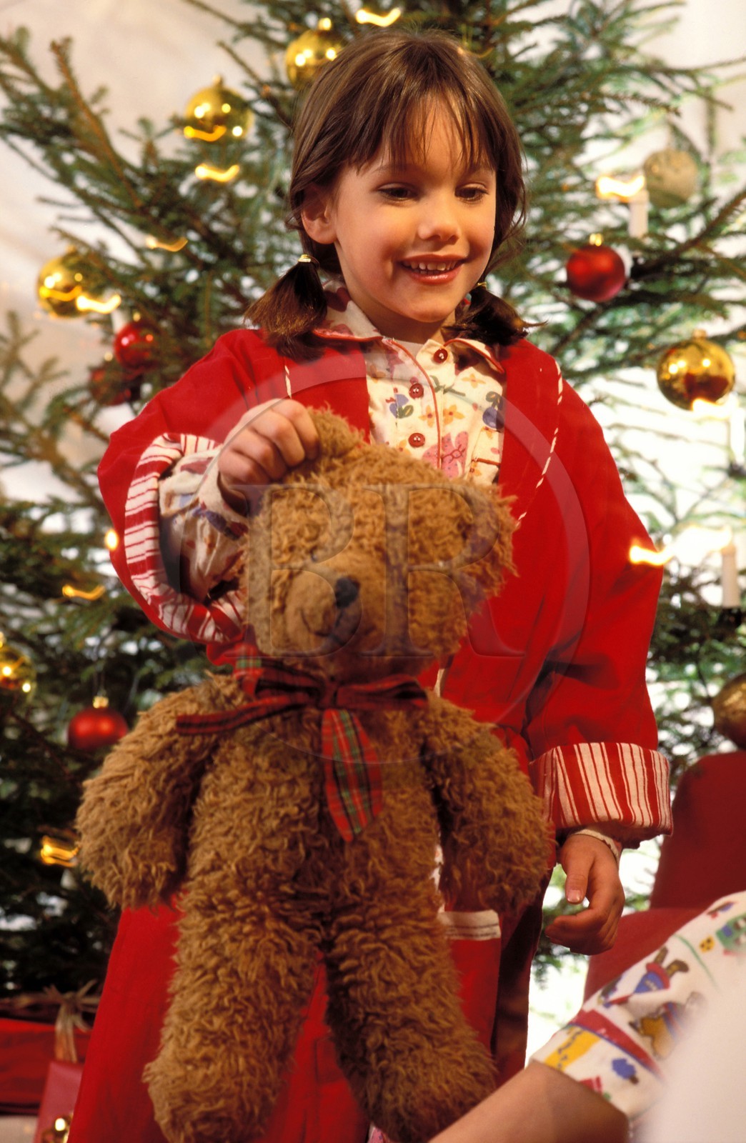 France, Christmas in family, after opening the presents, the little girl with her teddy bear