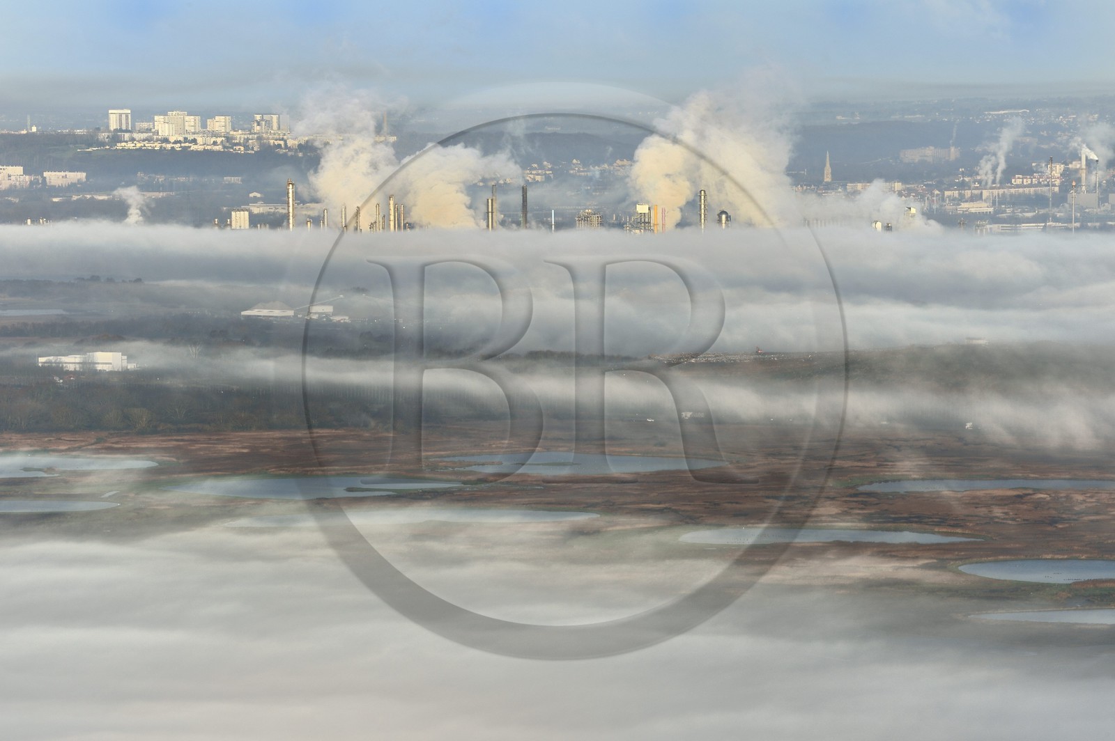 France, Seine Maritime, Le Havre, the factories of the port of Le Havre emerges from a sea of clouds behind the Natural Reserve of the Seine estuary