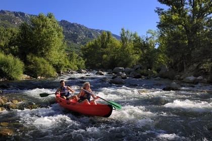 France, Herault, Orb valley, kayaking the river Orb at the moulin de Travassac next to Mons la Trivalle, the mount Caroux in the back