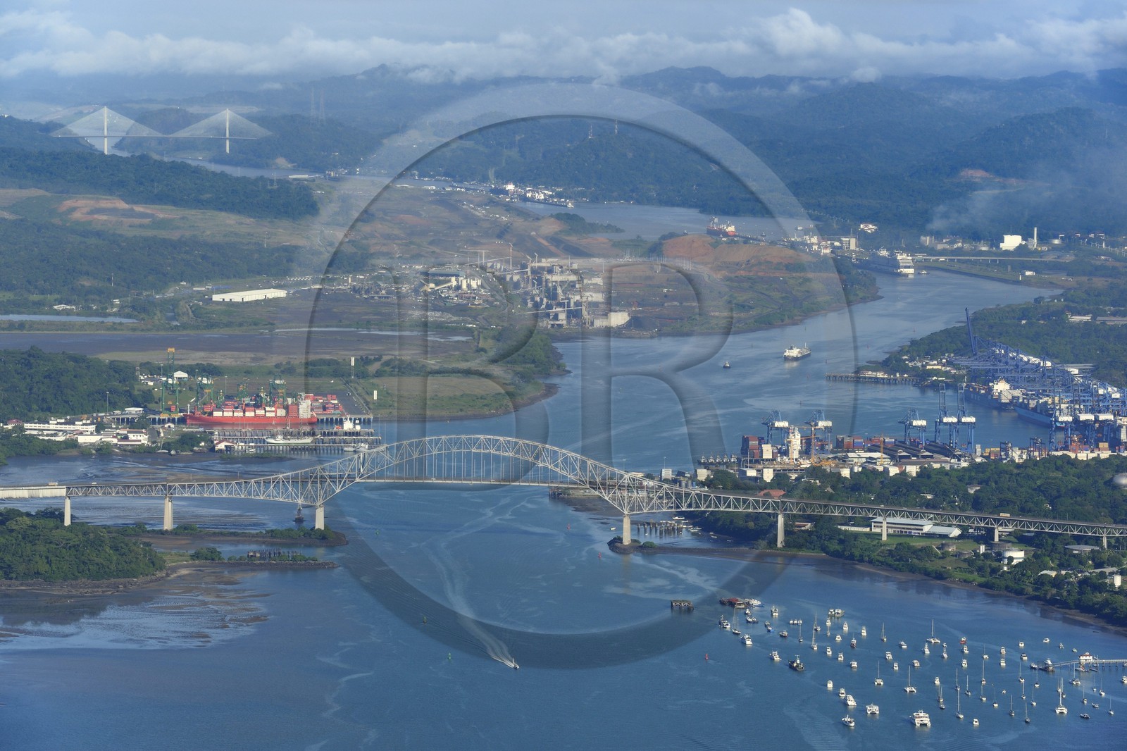 Panama, Panama City, the Bridge of the Americas (Puente de las Americas) over the Panama Canal access channel on the Pacific Ocean side, the Miraflores Locks in the background (aerial view)
