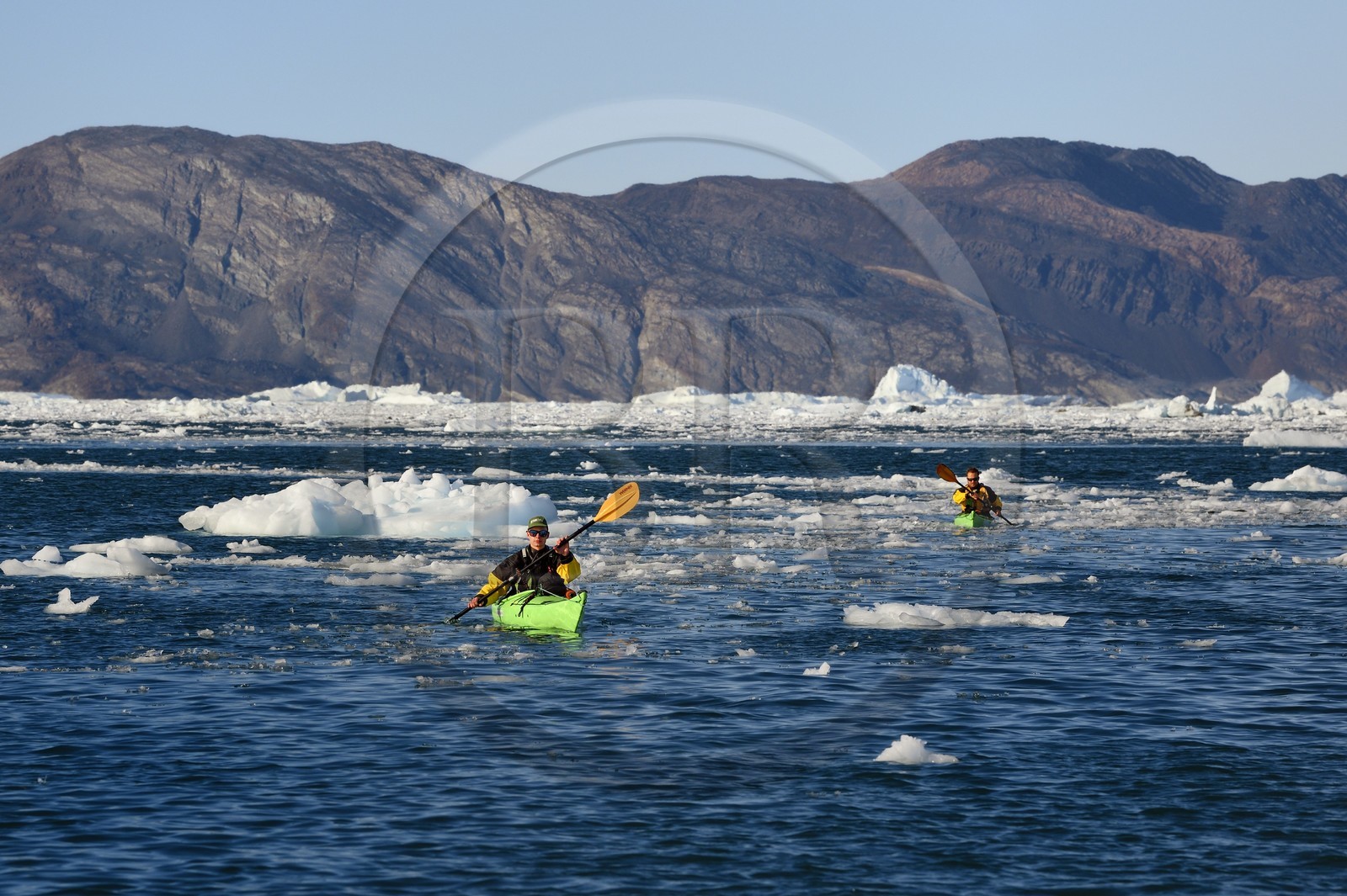 Greenland, west coast, Disko Bay, Quervain Bay, kayaks progressing among icebergs