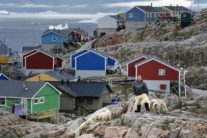Greenland, west coast, Uummannaq, the sled dog breeder Malti Suulutsun wearing bear skin trousers