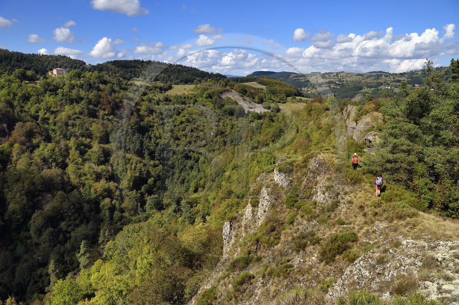France, Haute Loire, Loire river Valley, Lafarre, hikers progressing towards the Tour de Mariac from the 11th century ruins of the Chateau de Lafarre, on the left the stronghold of Cros de Lafarre above the gorges of La Langougniole, tributary of the Loire