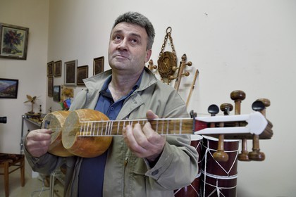 Azerbaijan, Shaki, traditional string instrument maker, the luthier Mahir Valadov reparing a tar (lute)